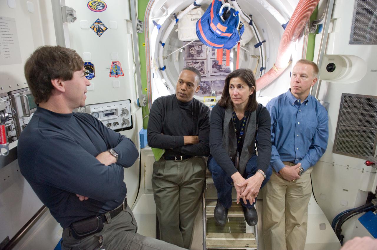 JSC2010-E-020705 (10 Feb. 2010) --- NASA astronauts Michael Barratt (left), Alvin Drew, Nicole Stott and Tim Kopra, all STS-133 mission specialists, participate in a training session in an International Space Station mock-up/trainer in the Space Vehicle Mock-up Facility at NASA's Johnson Space Center.