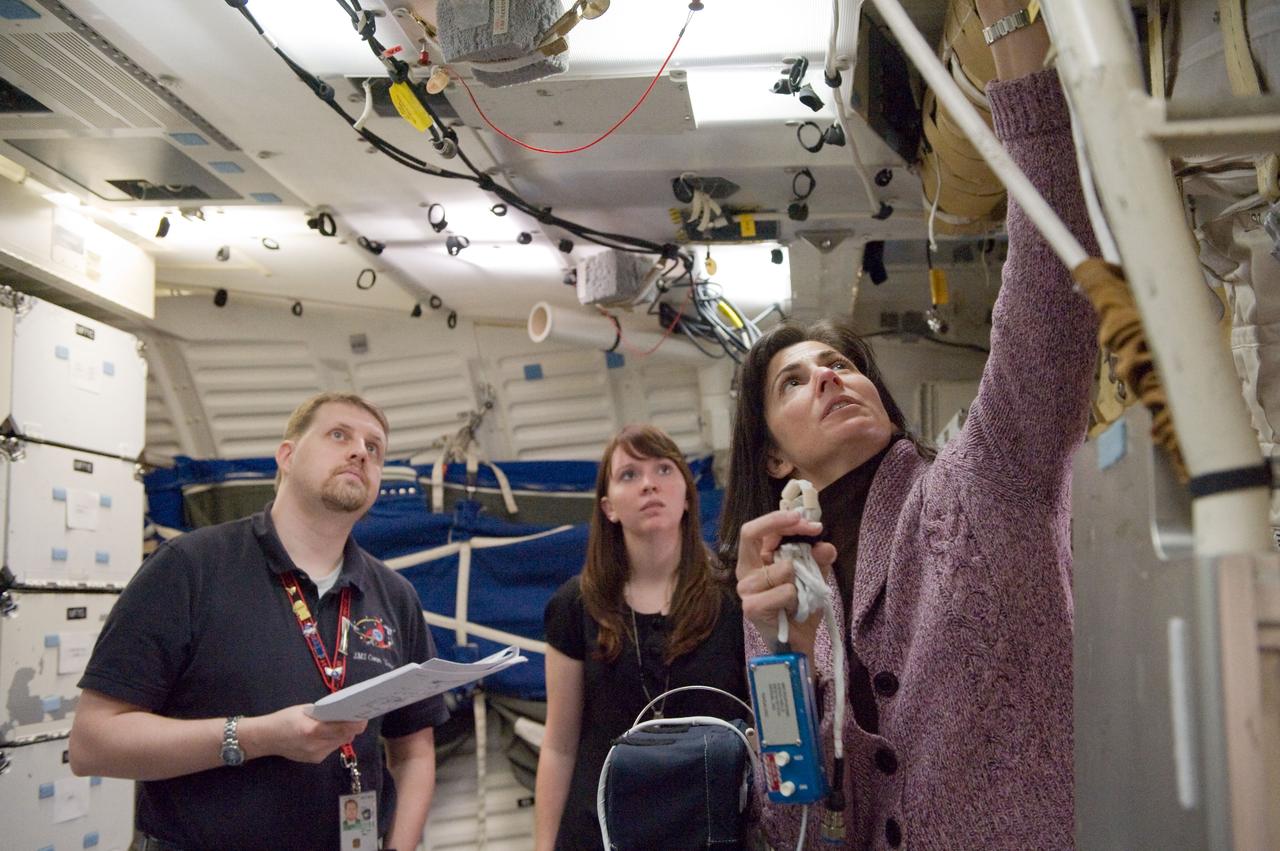 JSC2010-E-023633 (4 Feb. 2010) --- NASA astronaut Nicole Stott (right), STS-133 mission specialist, participates in training session in a shuttle mock-up in the Space Vehicle Mock-up Facility at NASA's Johnson Space Center. Instructors Shanna Andrew and James Gaustad assisted Stott.