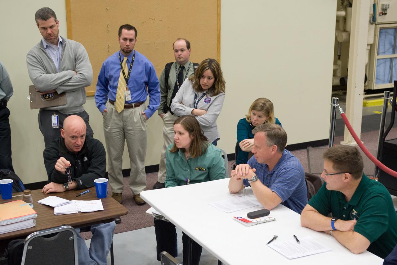 JSC2010-E-024375 (18 Feb. 2010) --- NASA astronauts Scott Kelly (seated, left), Expedition 25 flight engineer and Expedition 26 commander; Steve Lindsey (seated, second right), STS-133 commander; and Doug Wheelock (right), Expedition 24 flight engineer and Expedition 25 commander, participate in a training session in the Space Vehicle Mock-up Facility at NASA's Johnson Space Center.