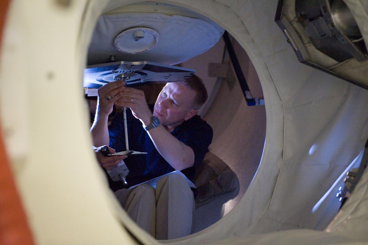 JSC2010-E-024380 (18 Feb. 2010) --- NASA astronaut Tim Kopra, STS-133 mission specialist, participates in a training session in an International Space Station mock-up/trainer in the Space Vehicle Mock-up Facility at NASA's Johnson Space Center.