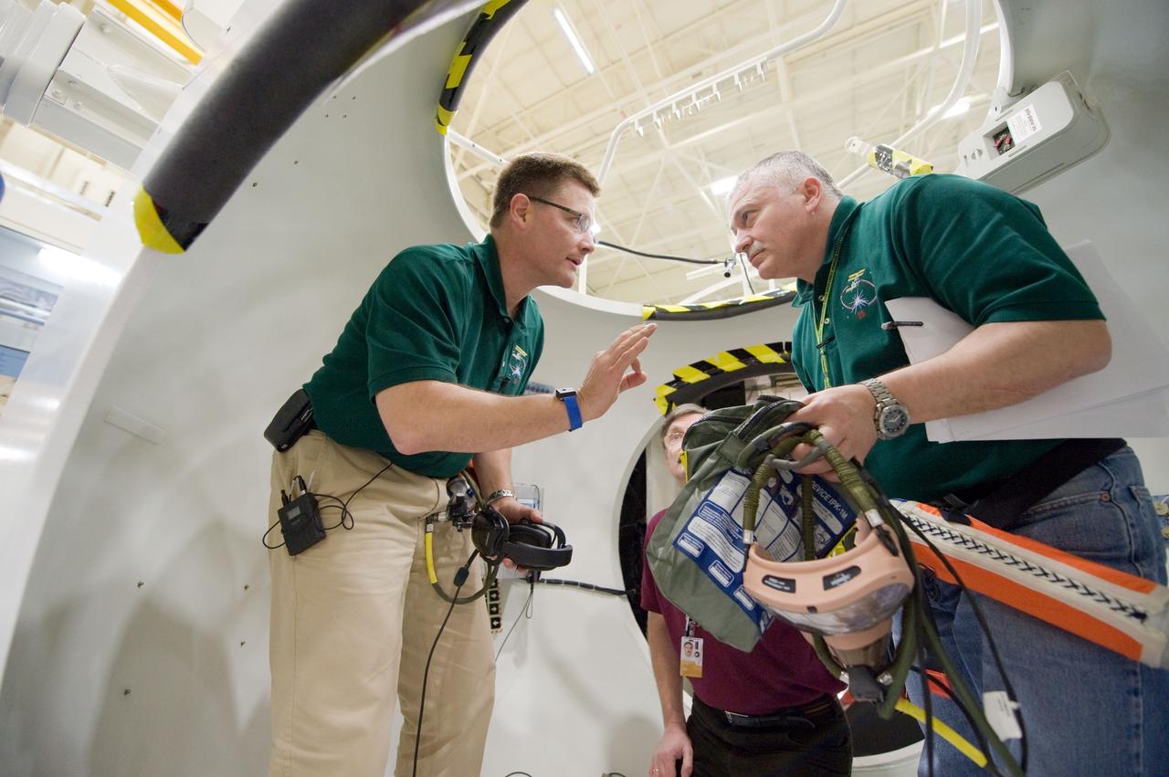 JSC2010-E-024381 (18 Feb. 2010) --- NASA astronaut Doug Wheelock (left), Expedition 24 flight engineer and Expedition 25 commander; and Russian cosmonaut Fyodor Yurchikhin, Expedition 24/25 flight engineer, participate in a training session in an International Space Station mock-up/trainer in the Space Vehicle Mock-up Facility at NASA's Johnson Space Center.