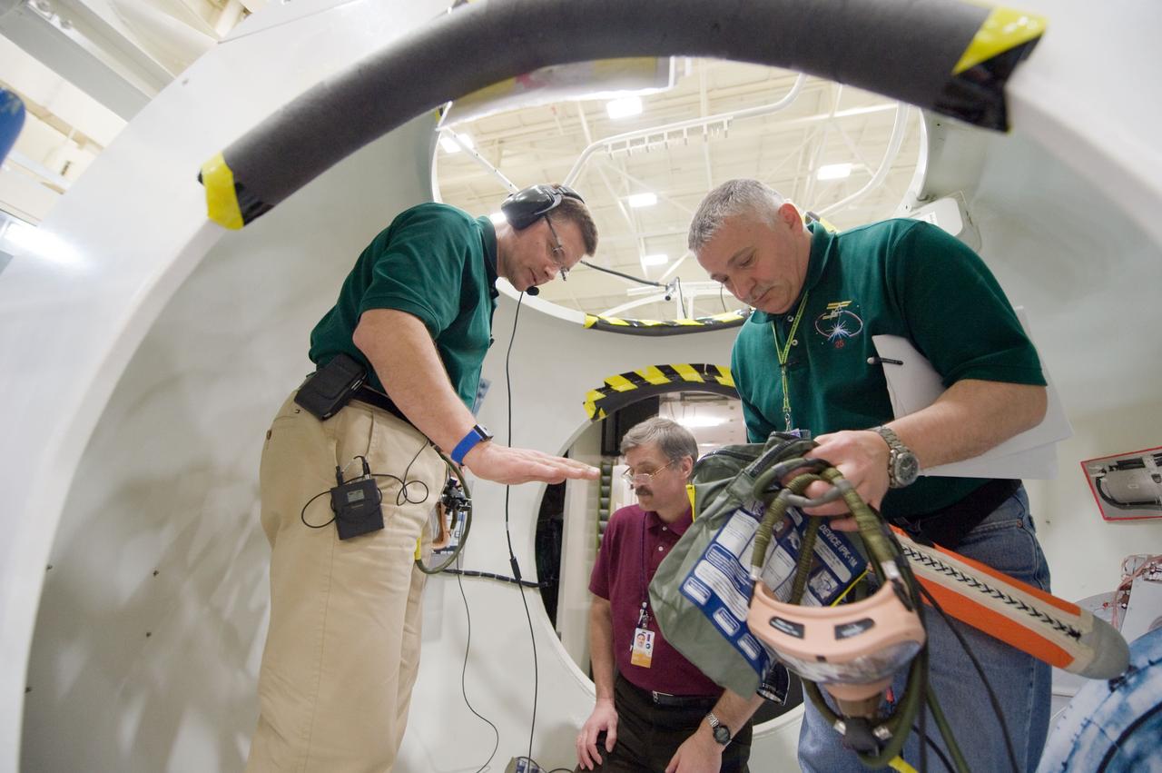 JSC2010-E-024382 (18 Feb. 2010) --- NASA astronaut Doug Wheelock (left), Expedition 24 flight engineer and Expedition 25 commander; along with Russian cosmonauts Fyodor Yurchikhin, Expedition 24/25 flight engineer; and Alexander Kaleri (background), Expedition 25/26 flight engineer, participate in a training session in an International Space Station mock-up/trainer in the Space Vehicle Mock-up Facility at NASA's Johnson Space Center.