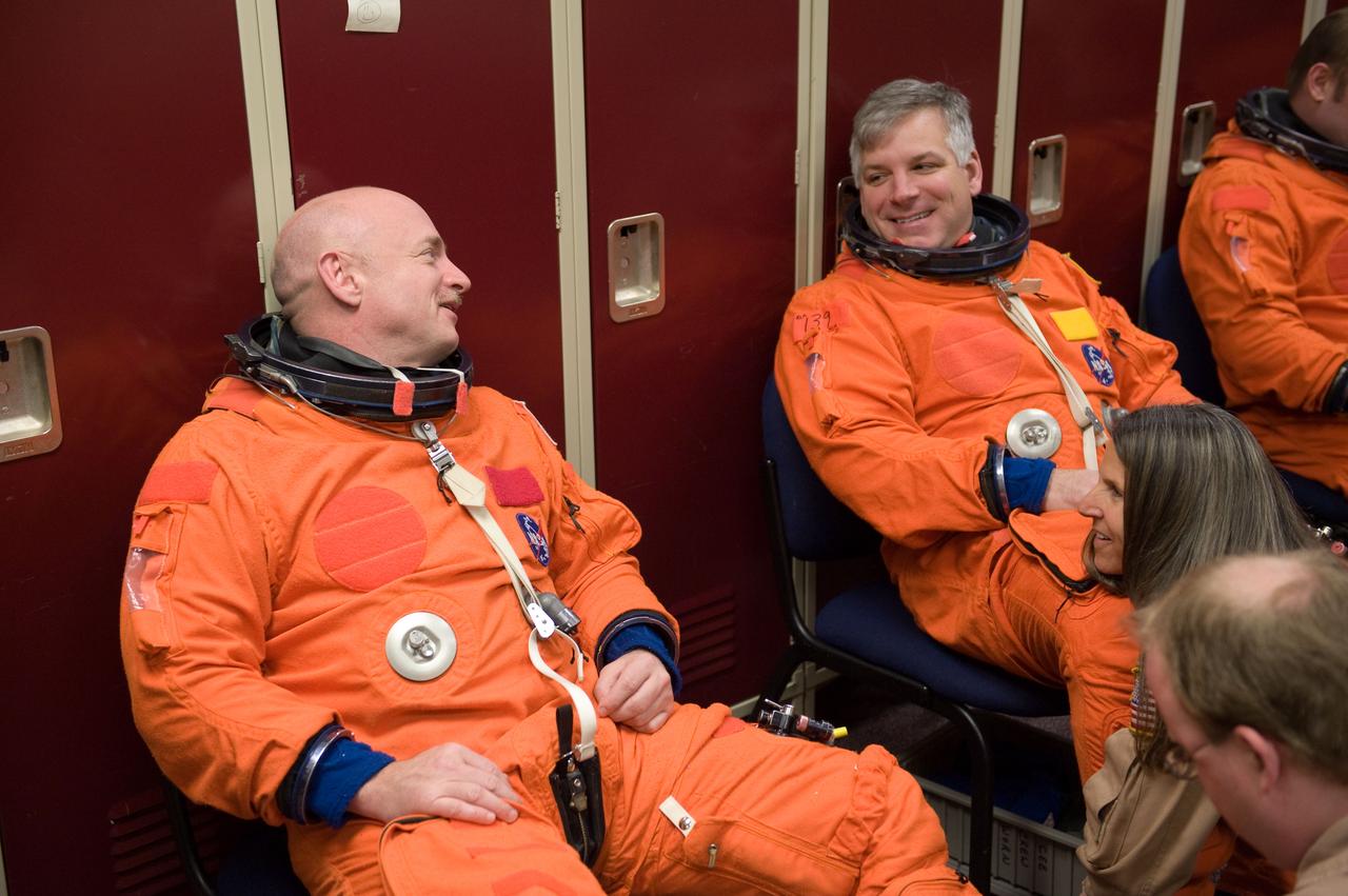 JSC2010-E-024581 (11 Feb. 2010) --- NASA astronauts Mark Kelly (left), STS-134 commander; and Gregory H. Johnson, pilot, attired in training versions of their shuttle launch and entry suits, prepare for a training session in the Space Vehicle Mock-up Facility at NASA's Johnson Space Center.