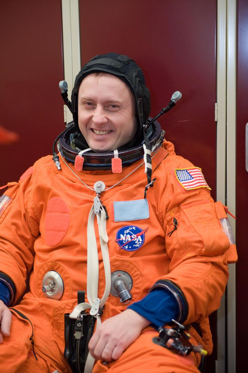 JSC2010-E-024583 (11 Feb. 2010) --- NASA astronaut Michael Fincke, STS-134 mission specialist, attired in a training version of his shuttle launch and entry suit, awaits the start of a training session in the Space Vehicle Mock-up Facility at NASA's Johnson Space Center.