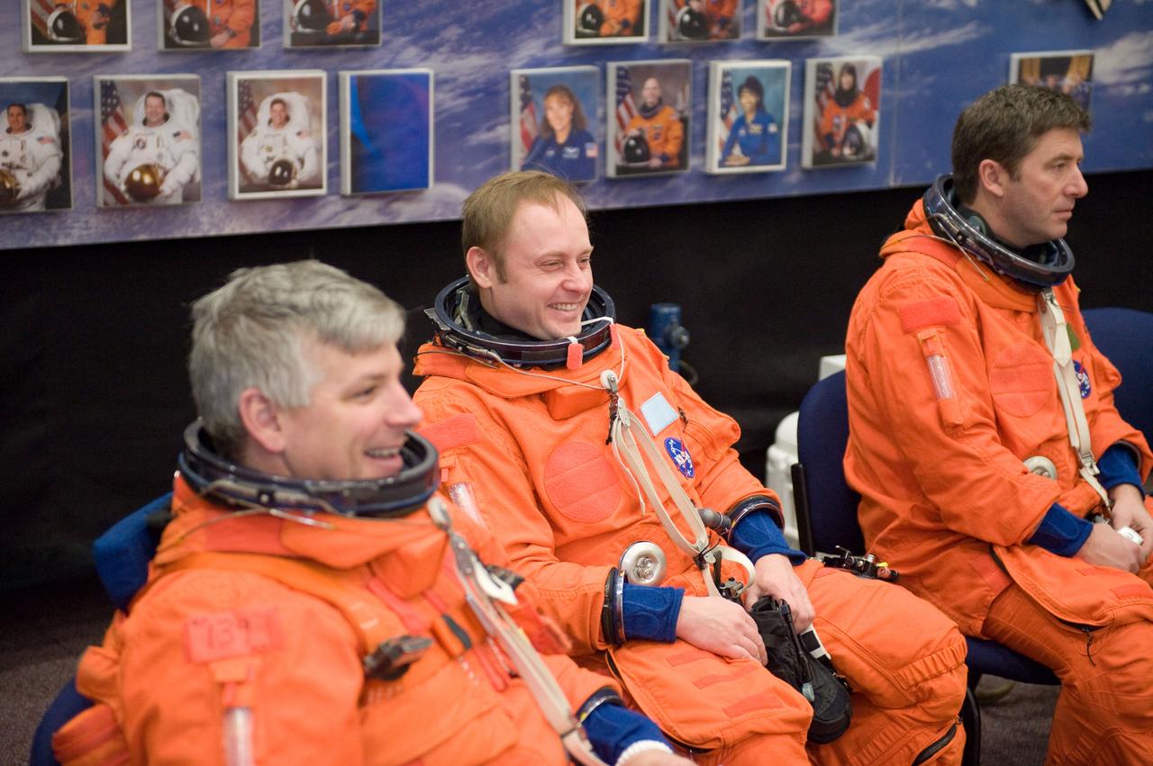 JSC2010-E-024591 (11 Feb. 2010) --- NASA astronaut Gregory H. Johnson (foreground), STS-134 pilot; along with NASA astronaut Michael Fincke (center) and European Space Agency astronaut Roberto Vittori, both mission specialists, attired in training versions of their shuttle launch and entry suits, await the start of a training session in the Space Vehicle Mock-up Facility at NASA's Johnson Space Center.