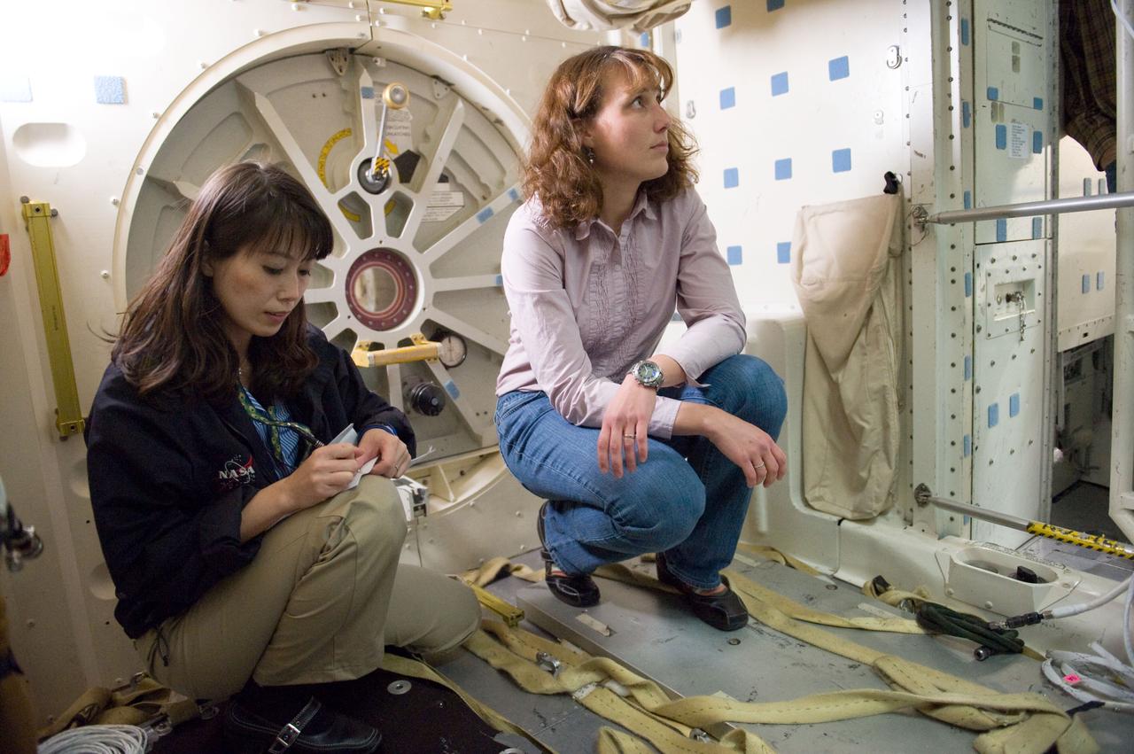 JSC2010-E-024621 (10 Feb. 2010) --- Japan Aerospace Exploration Agency (JAXA) astronaut Naoko Yamazaki (left) and NASA astronaut Dorothy Metcalf-Lindenburger, both STS-131 mission specialists, participate in an ingress/egress timeline training session in a shuttle mock-up in the Space Vehicle Mock-up Facility at NASA's Johnson Space Center.
