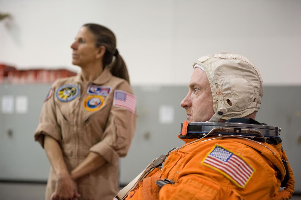 JSC2010-E-025680 (23 Feb. 2010) --- NASA astronaut Mark Kelly, STS-134 commander, attired in a training version of his shuttle launch and entry suit, is pictured during a water survival training session in the Neutral Buoyancy Laboratory (NBL) near NASA's Johnson Space Center. United Space Alliance suit technician Toni Cost-Davis is visible in the background.