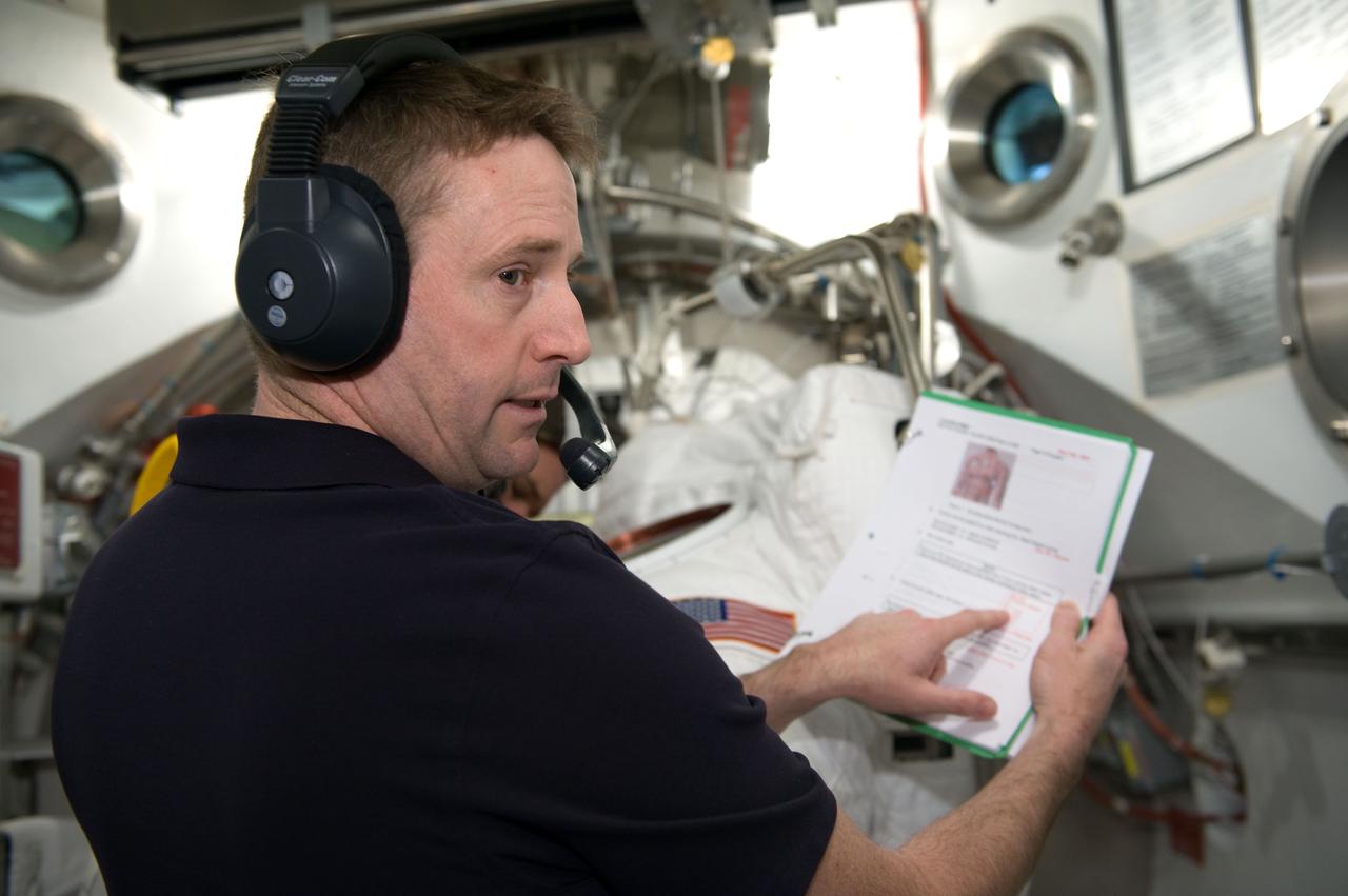 JSC2010-E-026874 (26 Feb. 2010) --- NASA astronaut Ken Ham, STS-132 commander, is pictured during an Extravehicular Mobility Unit (EMU) spacesuit fit check with astronaut Michael Good (out of frame), mission specialist, in the Space Station Airlock Test Article (SSATA) in the Crew Systems Laboratory at NASA's Johnson Space Center.