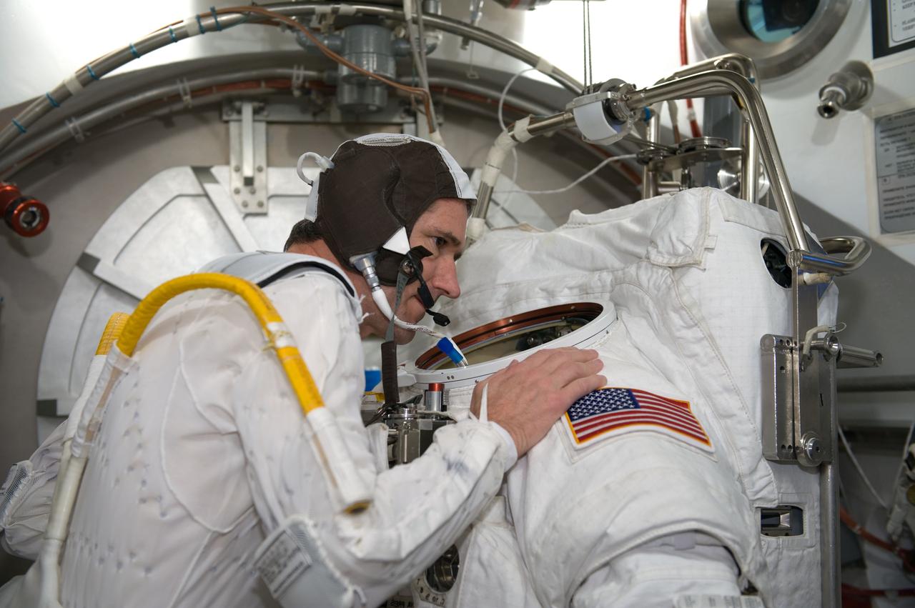 JSC2010-E-026875 (26 Feb. 2010) --- NASA astronaut Michael Good, STS-132 mission specialist, participates in an Extravehicular Mobility Unit (EMU) spacesuit fit check in the Space Station Airlock Test Article (SSATA) in the Crew Systems Laboratory at NASA's Johnson Space Center.