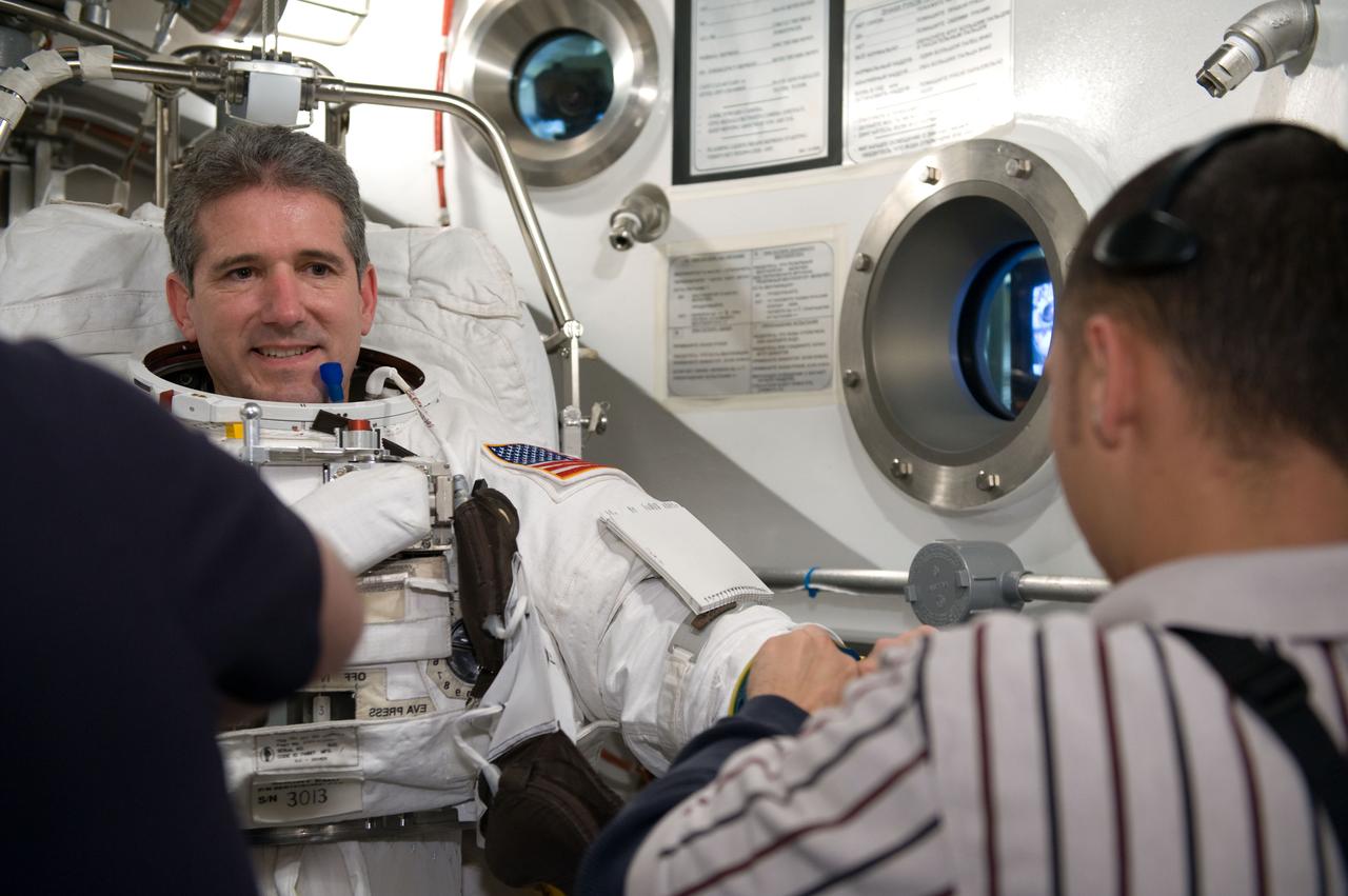 JSC2010-E-026877 (26 Feb. 2010) --- NASA astronaut Michael Good, STS-132 mission specialist, participates in an Extravehicular Mobility Unit (EMU) spacesuit fit check in the Space Station Airlock Test Article (SSATA) in the Crew Systems Laboratory at NASA's Johnson Space Center.