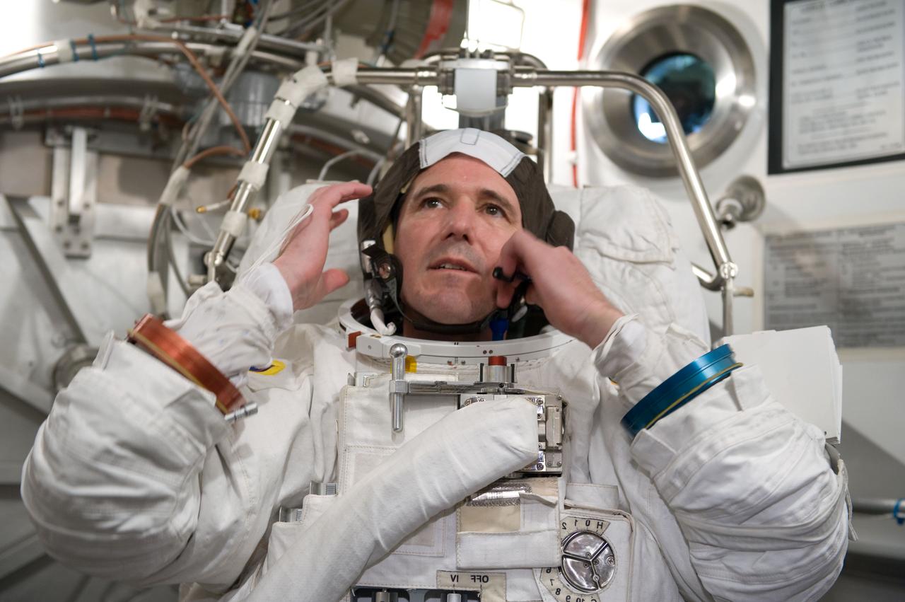 JSC2010-E-026880 (26 Feb. 2010) --- NASA astronaut Michael Good, STS-132 mission specialist, participates in an Extravehicular Mobility Unit (EMU) spacesuit fit check in the Space Station Airlock Test Article (SSATA) in the Crew Systems Laboratory at NASA's Johnson Space Center.
