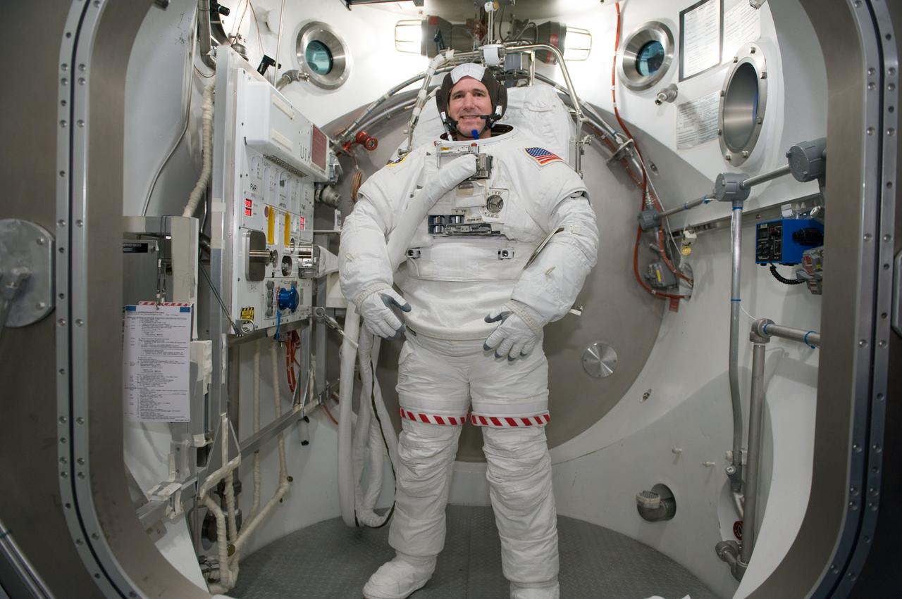 JSC2010-E-026889 (26 Feb. 2010) --- NASA astronaut Michael Good, STS-132 mission specialist, participates in an Extravehicular Mobility Unit (EMU) spacesuit fit check in the Space Station Airlock Test Article (SSATA) in the Crew Systems Laboratory at NASA's Johnson Space Center.