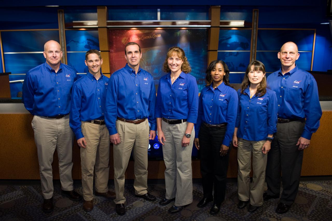 JSC2010-E-038821 (9 March 2010) --- NASA astronaut Alan Poindexter (far left) STS-131 mission commander, and his crew pose for photos during the press day event for the scheduled April mission. NASA astronauts Poindexter and James Dutton (second left) will serve as the commander and pilot, respectively. They will be joined by (from third left) astronauts  Rick Mastracchio, Dorothy Metcalf-Lindenburger, Stephanie Wilson, along with Naoko Yamazaki of the Japan Aerospace Exploration Agency, and Clayton Anderson, all mission specialists.