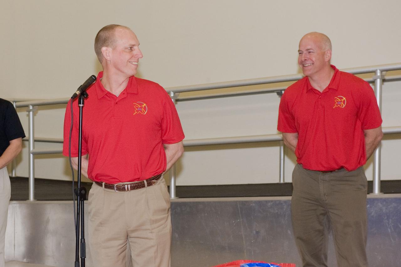 JSC2010-E-039293 (10 March 2010) --- NASA astronauts Alan Poindexter (right), STS-131 commander; and Clayton Anderson, mission specialist, are pictured during a cake-cutting ceremony in the Jake Garn Simulation and Training Facility at NASA's Johnson Space Center.
