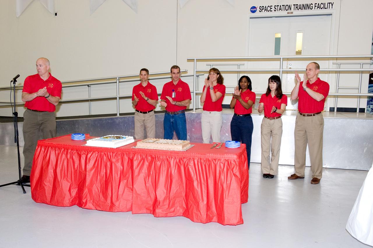 JSC2010-E-039296 (10 March 2010) --- NASA astronaut Alan Poindexter (left), STS-131 commander, speaks to a crowd during a cake-cutting ceremony in the Jake Garn Simulation and Training Facility at NASA's Johnson Space Center. Also pictured from the second left are NASA astronauts James P. Dutton Jr., pilot; Rick Mastracchio, Dorothy Metcalf-Lindenburger, Stephanie Wilson, Japan Aerospace Exploration Agency?s Naoko Yamazaki and NASA astronaut Clayton Anderson, all mission specialists.
