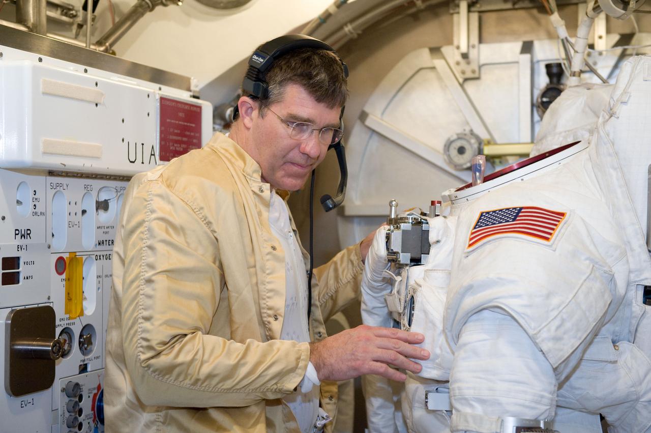 JSC2010-E-039444 (10 March 2010) --- NASA astronaut Steve Bowen, STS-132 mission specialist, participates in an Extravehicular Mobility Unit (EMU) spacesuit fit check in the Space Station Airlock Test Article (SSATA) in the Crew Systems Laboratory at NASA's Johnson Space Center.