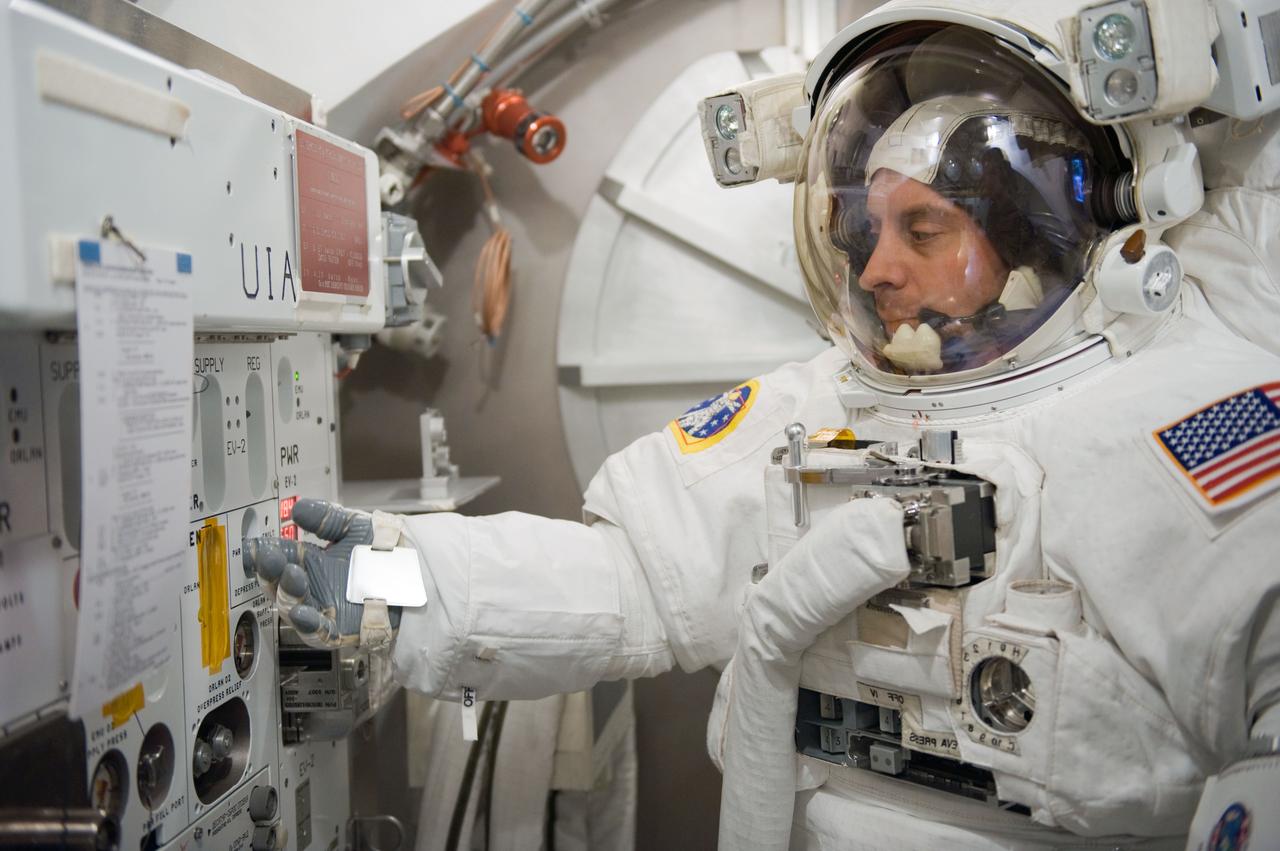 JSC2010-E-041279 (17 March 2010) --- NASA astronaut Garrett Reisman, STS-132 mission specialist, participates in an Extravehicular Mobility Unit (EMU) spacesuit fit check in the Space Station Airlock Test Article (SSATA) in the Crew Systems Laboratory at NASA's Johnson Space Center.