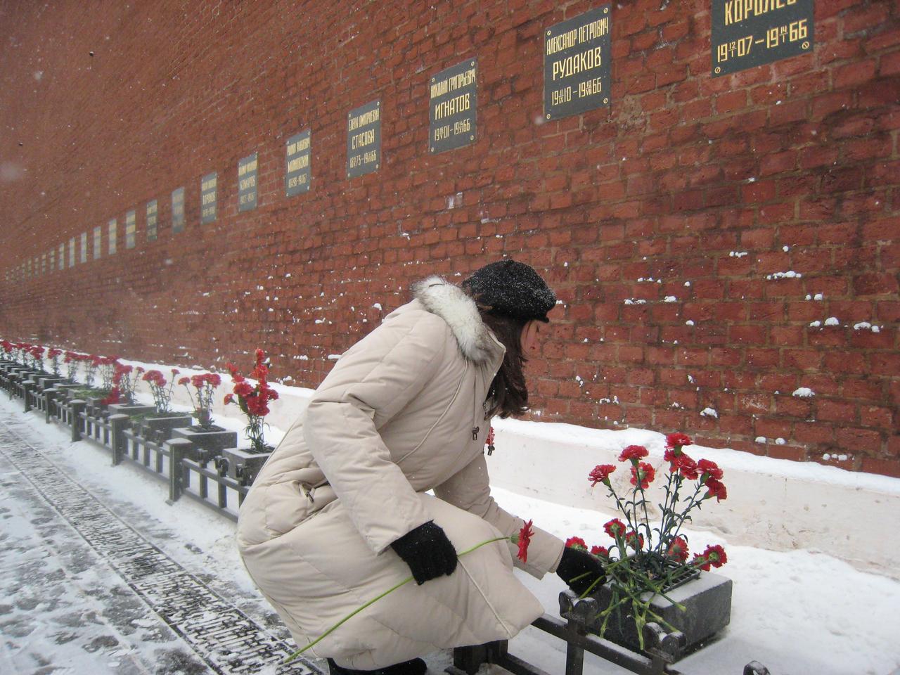 JSC2010-E-041314 (19 March 2010) --- At the Kremlin Wall in Red Square in Moscow March 19, 2010, NASA astronaut Tracy Caldwell Dyson, Expedition 23 flight engineer, lays flowers in a traditional ceremony prior to her departure for the launch site at the Baikonur Cosmodrome in Kazakhstan for final preparations for her launch on the Soyuz TMA-18 spacecraft to the International Space Station April 2. Caldwell Dyson, Russian cosmonauts Alexander Skvortsov, Soyuz commander, and  Mikhail Kornienko, Expedition 23 flight engineer,  were certified for launch earlier in the day by the Russian State Commission. Photo credit: NASA/Stephanie Stoll