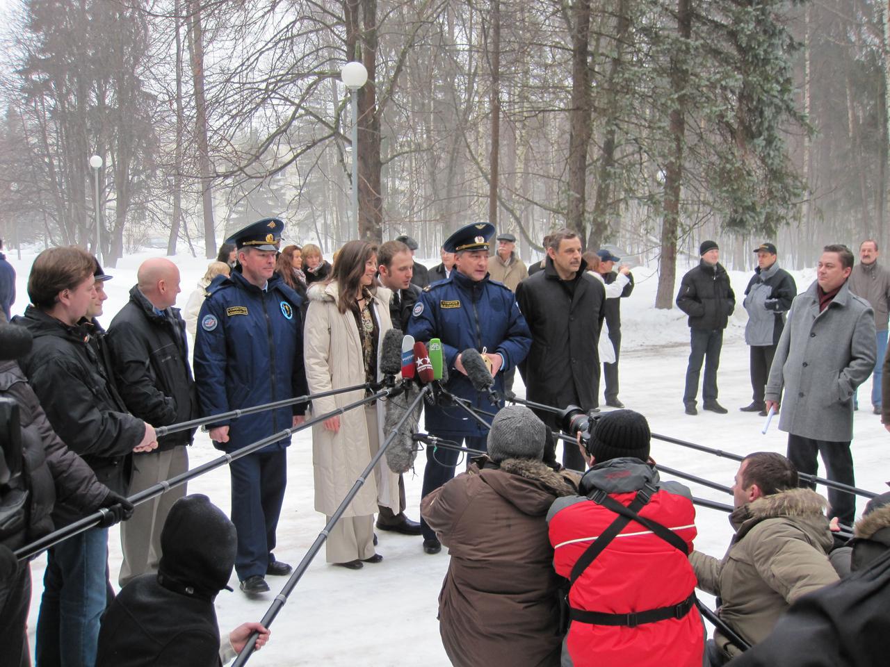At the Gagarin Cosmonaut Training Center in Star City, Russia, Expedition 23 Flight Engineer Tracy Caldwell Dyson (c, in white coat), Soyuz Commander Alexander Skvortsov (to her left) and Flight Engineer Mikhail Kornienko (r) answer questions from reporters following a a ceremony March 21, 2010 prior to their departure for the Baikonur Cosmodrome in Kazakhstan for final training prior to their launch April 2 on the Soyuz TMA-18 spacecraft. Also attending were backup Flight Engineer Scott Kelly (without hat, third from left) and backup Soyuz Commander Alexander Samokutyayev (to Kelly’s left).  Credit: NASA/Mark Bowman 