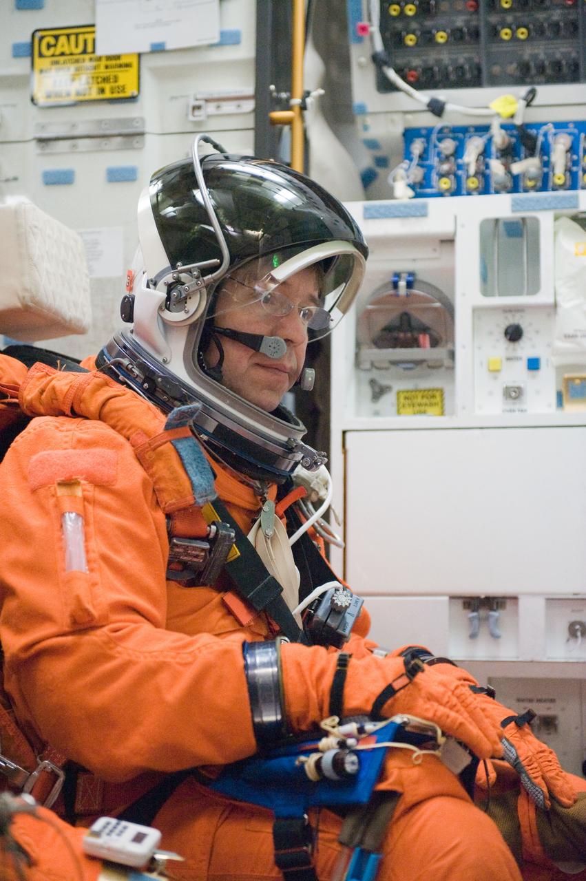 JSC2010-E-042088 (23 March 2010) --- NASA astronaut Michael Barratt, STS-133 mission specialist, participates in a post insertion/de-orbit training session on the middeck of the crew compartment trainer (CCT-2) in the Space Vehicle Mockup Facility at NASA's Johnson Space Center. Barratt is wearing a training version of his shuttle launch and entry suit.