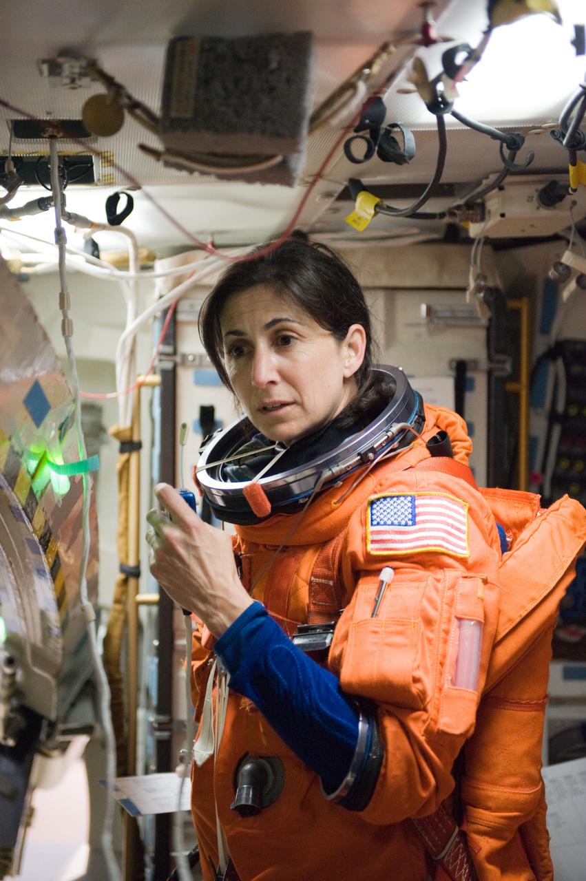 JSC2010-E-042092 (23 March 2010) --- Attired in a training version of her shuttle launch and entry suit, NASA astronaut Nicole Stott, STS-133 mission specialist, participates in a post insertion/de-orbit training session on the middeck of the crew compartment trainer (CCT-2) in the Space Vehicle Mockup Facility at NASA's Johnson Space Center.