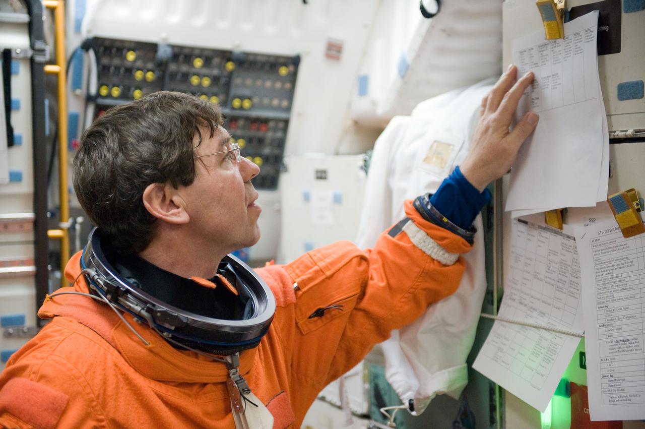 JSC2010-E-042094 (23 March 2010) --- Attired in a training version of his shuttle launch and entry suit, NASA astronaut Michael Barratt, STS-133 mission specialist, participates in a post insertion/de-orbit training session on the middeck of the crew compartment trainer (CCT-2) in the Space Vehicle Mockup Facility at NASA's Johnson Space Center.
