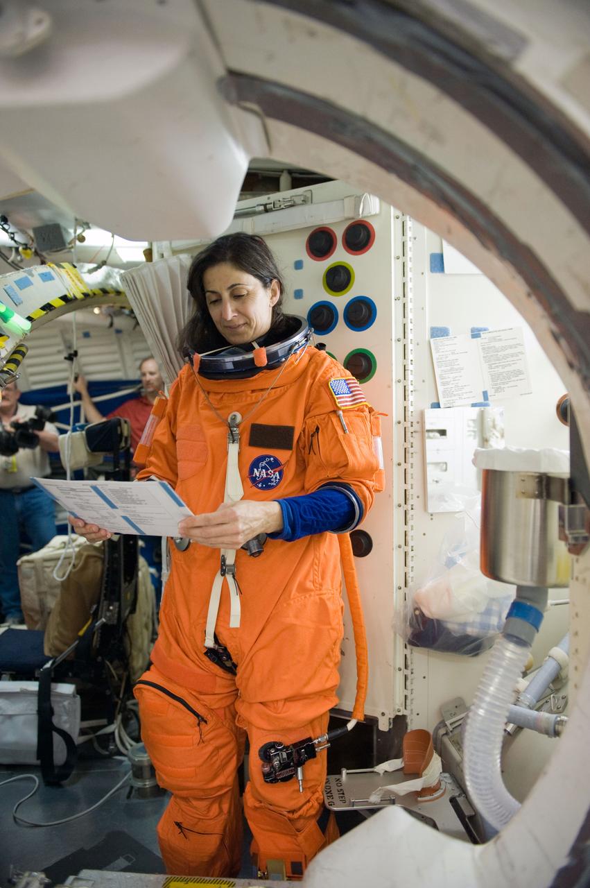 JSC2010-E-042095 (23 March 2010) --- Attired in a training version of her shuttle launch and entry suit, NASA astronaut Nicole Stott, STS-133 mission specialist, participates in a post insertion/de-orbit training session on the middeck of the crew compartment trainer (CCT-2) in the Space Vehicle Mockup Facility at NASA's Johnson Space Center.