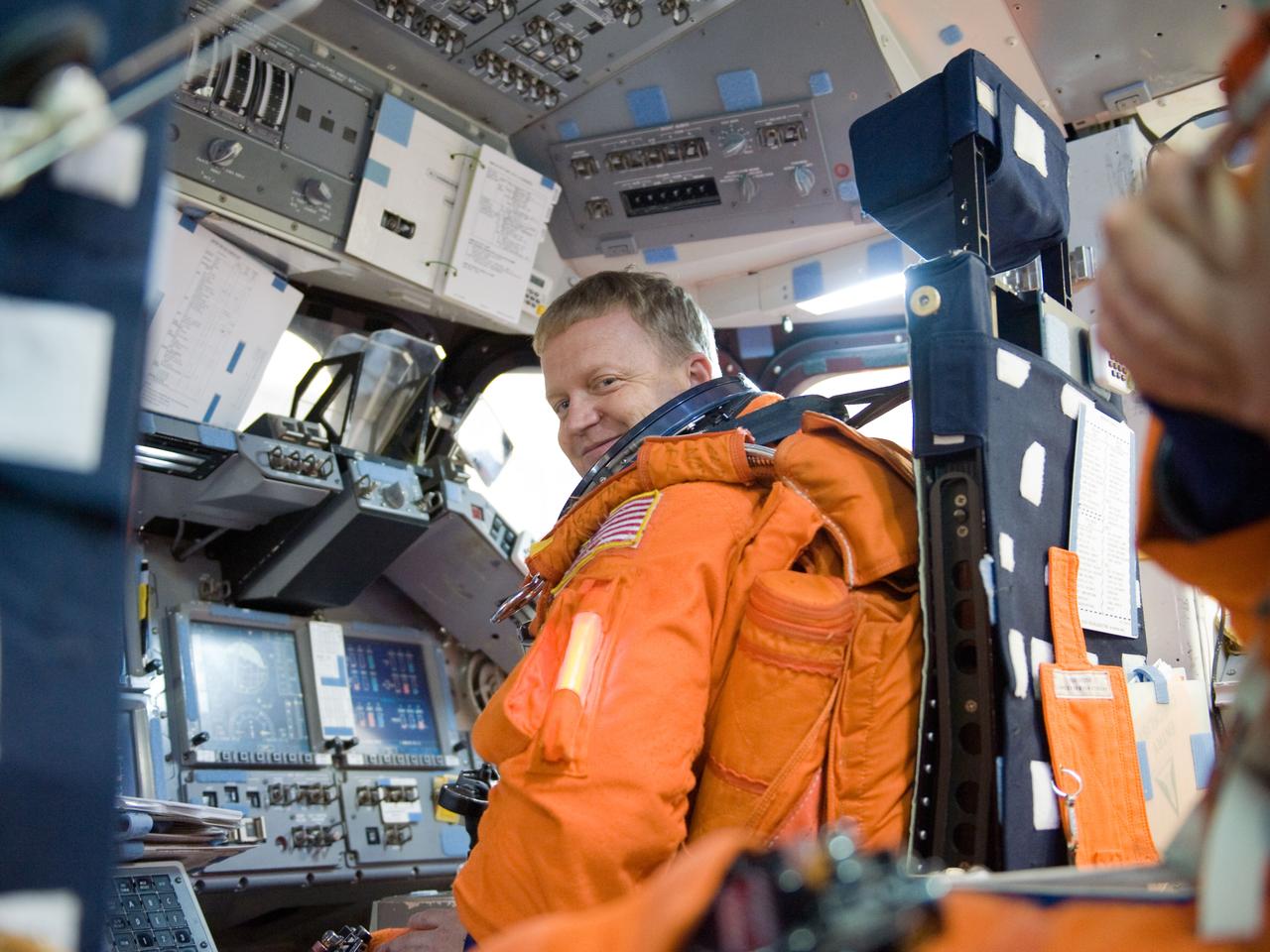 JSC2010-E-042108 (23 March 2010) --- While seated at the pilot?s station, NASA astronaut Eric Boe, STS-133 pilot, participates in a post insertion/de-orbit training session in the crew compartment trainer (CCT-2) in the Space Vehicle Mock-up Facility at NASA's Johnson Space Center. Boe is wearing a training version of his shuttle launch and entry suit.