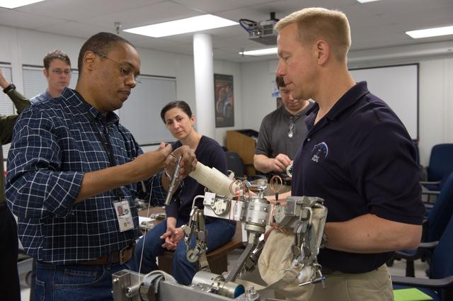 NASA image: STS-133 crew during ISS Small Tools training with instructor Jake Delap. 