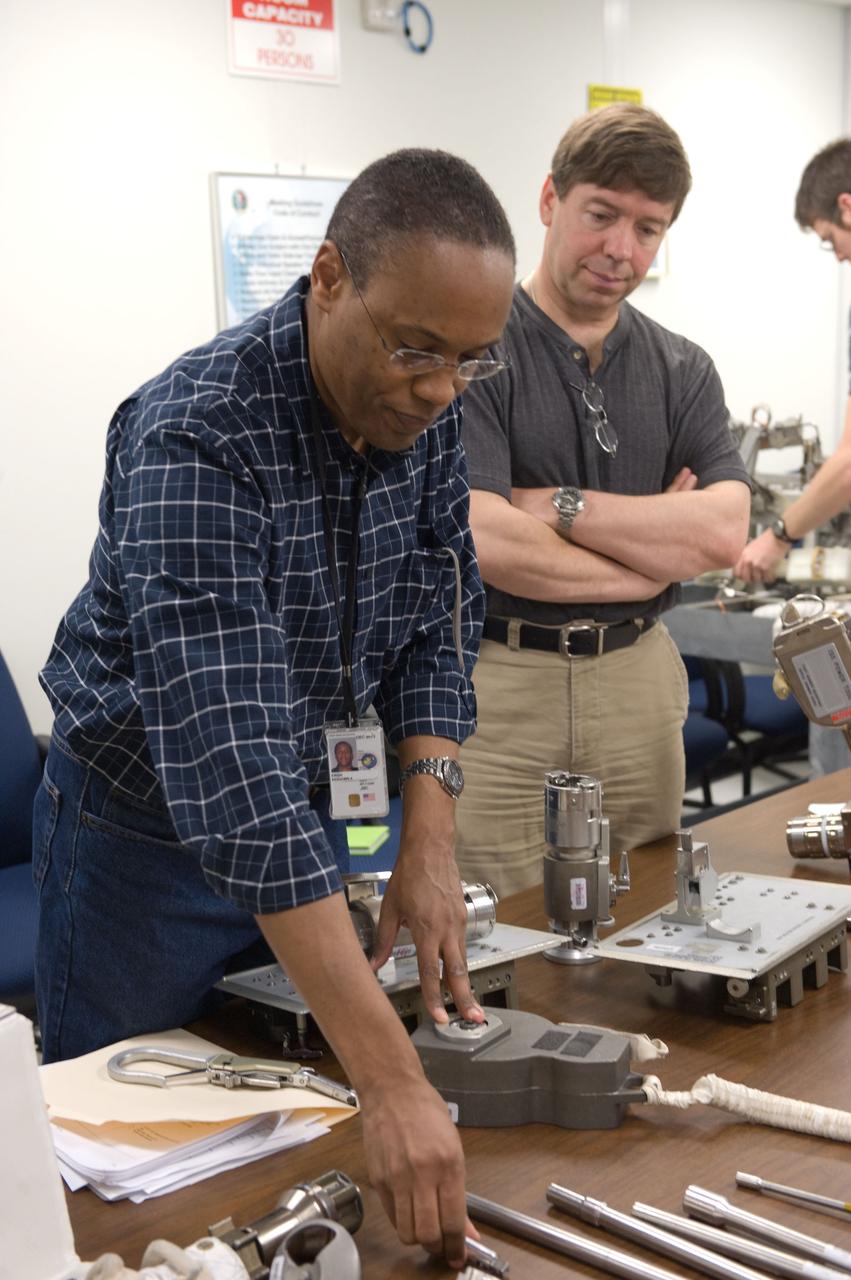 JSC2010-E-042736 (25 March 2010) --- NASA astronauts Alvin Drew (left) and Michael Barratt, both STS-133 mission specialists, participate in an ISS small tools training session in the Neutral Buoyancy Laboratory (NBL) near NASA's Johnson Space Center.