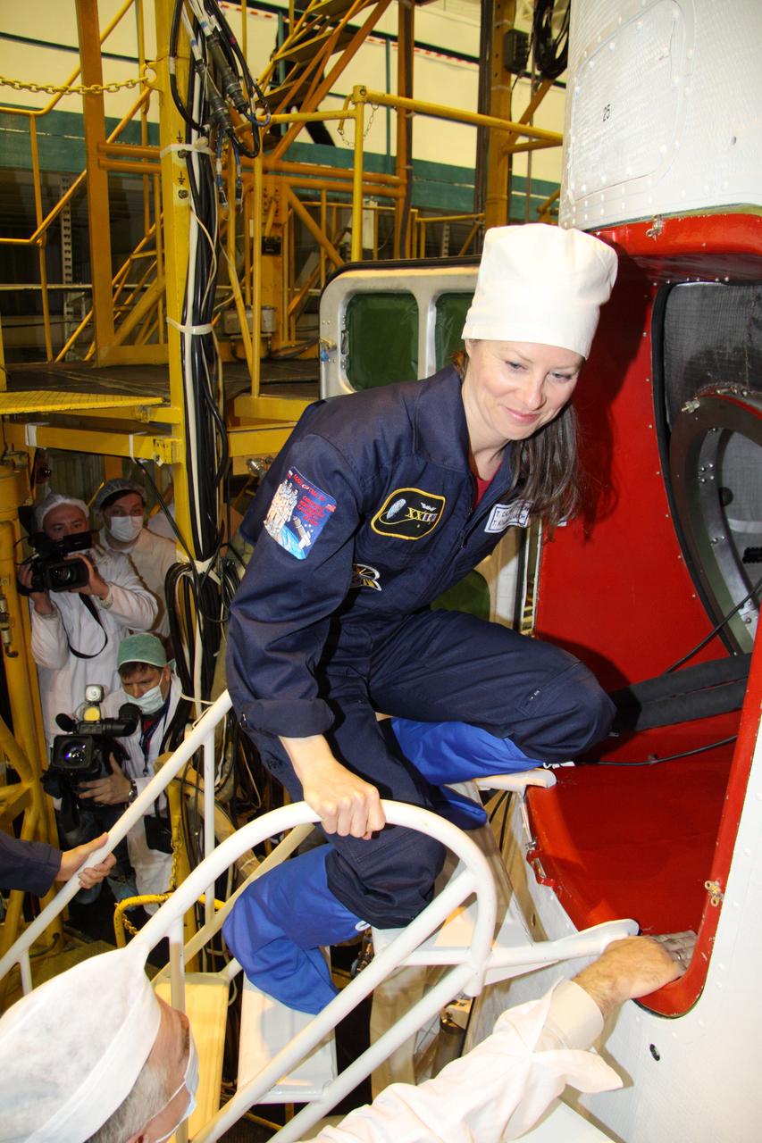 JSC2010-E-043836 (29 March 2010) --- NASA astronaut Tracy Caldwell Dyson, Expedition 23 flight engineer, participates in the final unsuited Soyuz fit check on March 29, 2010 at the Baikonur Cosmodrome, Kazakhstan. She and two Russian cosmonauts are scheduled to launch aboard the Soyuz TMA-18 spacecraft on April 2 (Kazakhstan time). Photo credit: NASA/Victor Zelentsov