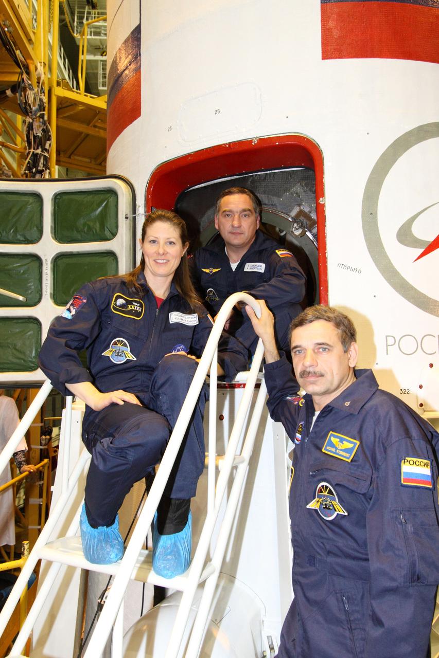 JSC2010-E-043837 (29 March 2010) --- The Expedition 23 crew poses for pictures in front of their Soyuz TMA-18 following the final fit check at Baikonur Cosmodrome on March 29, 2010. From left are NASA astronaut Tracy Caldwell Dyson, flight engineer, with Russian cosmonauts Alexander Skvortsov, Soyuz commander and Expedition 23 flight engineer; and Mikhail Kornienko, flight engineer. Photo credit: NASA/Victor Zelentsov