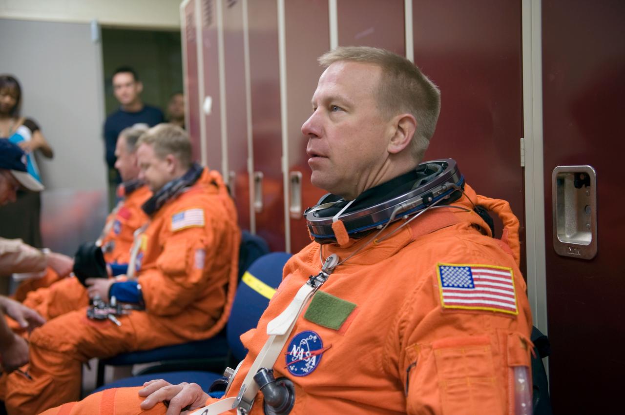 JSC2010-E-043919 (26 March 2010) --- NASA astronaut Tim Kopra, STS-133 mission specialist, attired in a training version of his shuttle launch and entry suit, awaits the start of a training session in the Space Vehicle Mock-up Facility at NASA's Johnson Space Center.