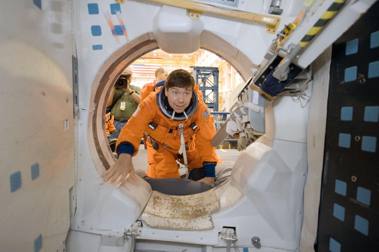 JSC2010-E-043938 (26 March 2010) --- NASA astronaut Michael Barratt, STS-133 mission specialist, attired in a training version of his shuttle launch and entry suit, participates in a training session in the Space Vehicle Mock-up Facility at NASA's Johnson Space Center.