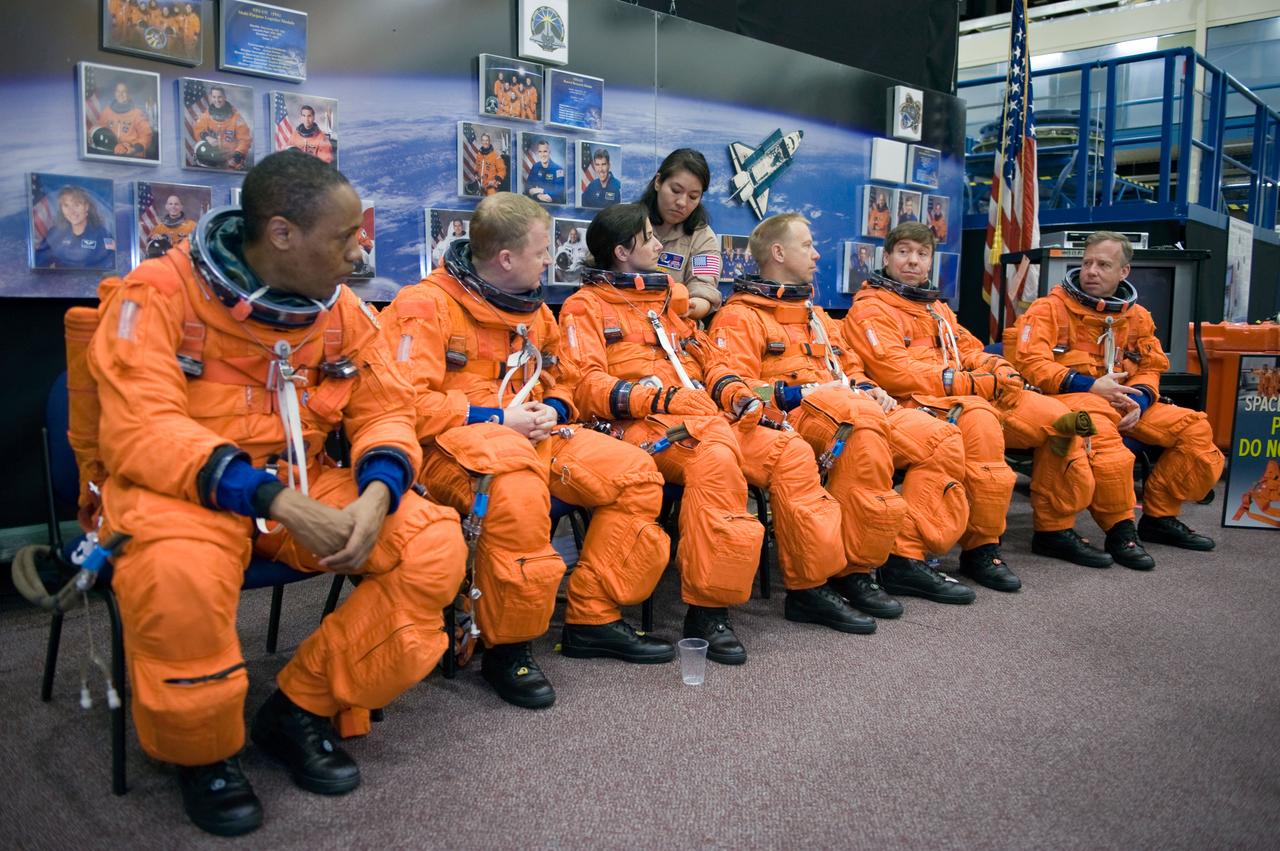 JSC2010-E-043954 (26 March 2010) --- Attired in training versions of their shuttle launch and entry suits, STS-133 crew members await the start of a training session in the crew compartment trainer (CCT-2) in the Space Vehicle Mockup Facility at NASA's Johnson Space Center. Pictured from the right are NASA astronauts Steve Lindsey, commander; Michael Barratt, Tim Kopra, Nicole Stott, all mission specialists; Eric Boe, pilot; and Alvin Drew, mission specialist.