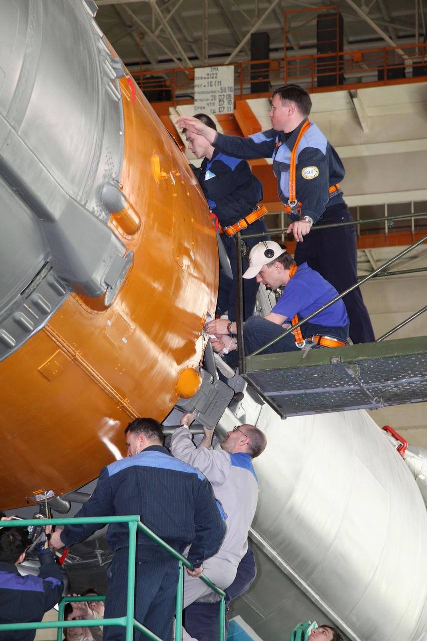 JSC2010-E-044365 (30 March 2010) --- In preparation for an April 2 liftoff for Expedition 23, the final assembly for Soyuz TMA-18 was performed March 30 by TsSKB-Progress personnel in the Launch Vehicle Assembly facility at Site 112 of Baikonur Cosmodrome. Photo credit: NASA/Victor Zelentsov