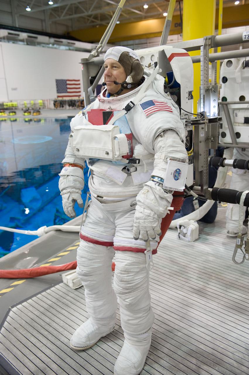 JSC2010-E-046449 (31 March 2010) --- NASA astronaut Tim Kopra, STS-133 mission specialist, attired in a training version of his Extravehicular Mobility Unit (EMU) spacesuit, awaits the start of a spacewalk training session in the waters of the Neutral Buoyancy Laboratory (NBL) near NASA's Johnson Space Center.