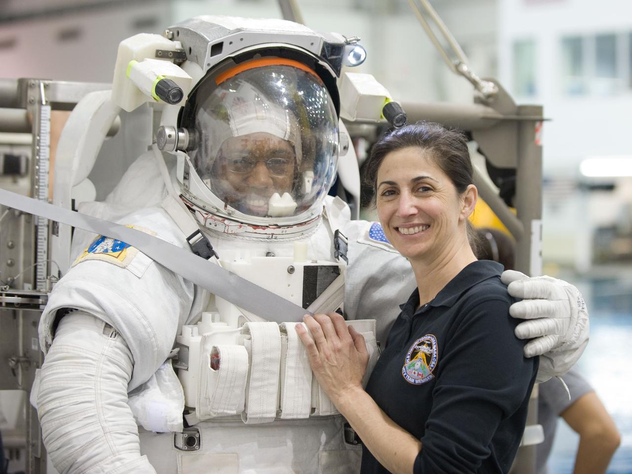 JSC2010-E-046457 (31 March 2010) --- NASA astronauts Alvin Drew, attired in a training version of his Extravehicular Mobility Unit (EMU) spacesuit, and Nicole Stott, both STS-133 mission specialists, take a moment for a photo prior to the start of Drew?s spacewalk training session in the waters of the Neutral Buoyancy Laboratory (NBL) near NASA's Johnson Space Center.