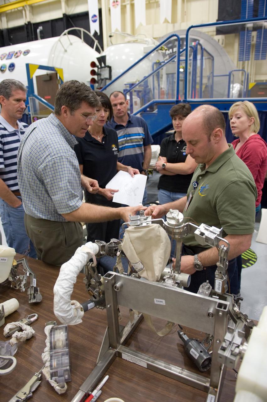 JSC2010-E-046531 (2 April 2010) --- NASA astronauts Garrett Reisman (right), Steve Bowen and Michael Good (far left), all STS-132 mission specialists, participate in an EVA tool training session in the Space Vehicle Mockup Facility at NASA's Johnson Space Center.