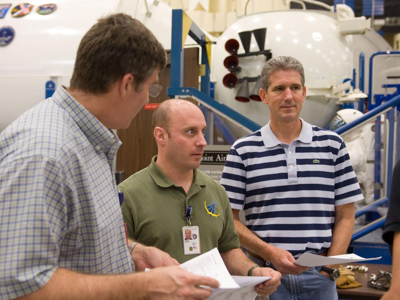 JSC2010-E-046533 (2 April 2010) --- NASA astronauts Steve Bowen (left), Garrett Reisman and Michael Good, all STS-132 mission specialists, participate in an EVA tool training session in the Space Vehicle Mockup Facility at NASA's Johnson Space Center.