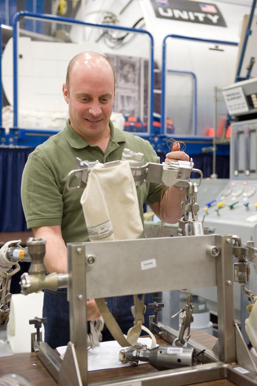 JSC2010-E-046537 (2 April 2010) --- NASA astronaut Garrett Reisman, STS-132 mission specialist, participates in an EVA tool training session in the Space Vehicle Mockup Facility at NASA's Johnson Space Center.
