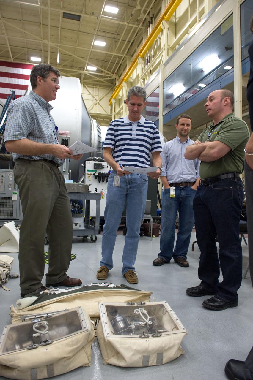 JSC2010-E-046541 (2 April 2010) --- NASA astronauts Steve Bowen (left), Michael Good and Garrett Reisman, all STS-132 mission specialists, participate in an EVA tool training session in the Space Vehicle Mockup Facility at NASA's Johnson Space Center.