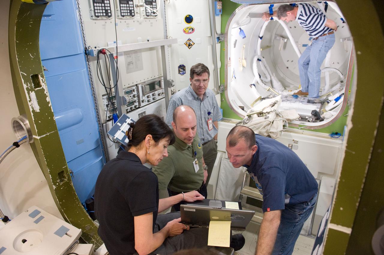 JSC2010-E-046543 (2 April 2010) --- NASA astronauts Tony Antonelli (right), STS-132 pilot; Garrett Reisman and Steve Bowen, both mission specialists; along with Ken Ham (background), commander, participate in a training session in an International Space Station mock-up/trainer in the Space Vehicle Mock-up Facility at NASA's Johnson Space Center.