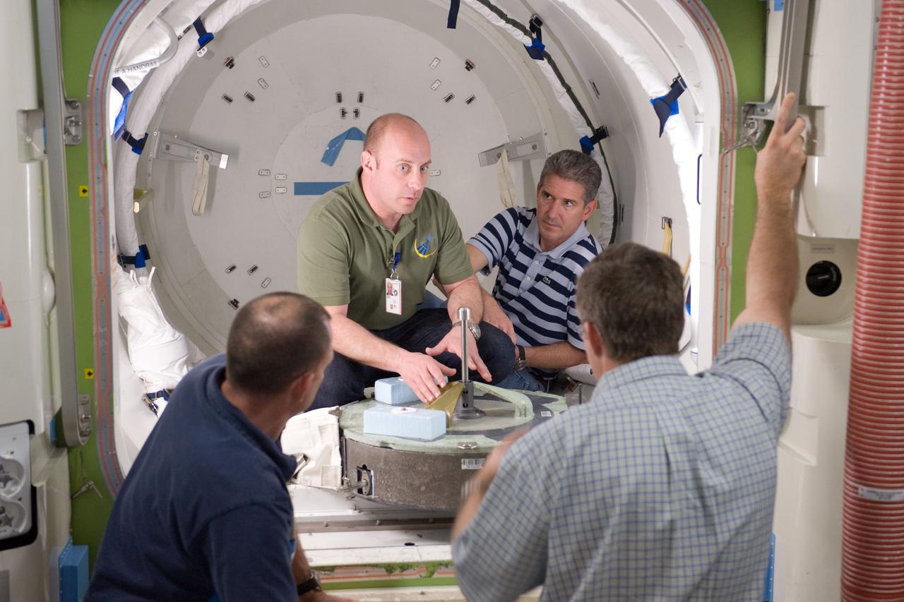 JSC2010-E-046544 (2 April 2010) --- NASA astronauts Tony Antonelli (left foreground), STS-132 pilot; Garrett Reisman (left background), Michael Good and Steve Bowen, all mission specialists, participate in a training session in an International Space Station mock-up/trainer in the Space Vehicle Mock-up Facility at NASA's Johnson Space Center.