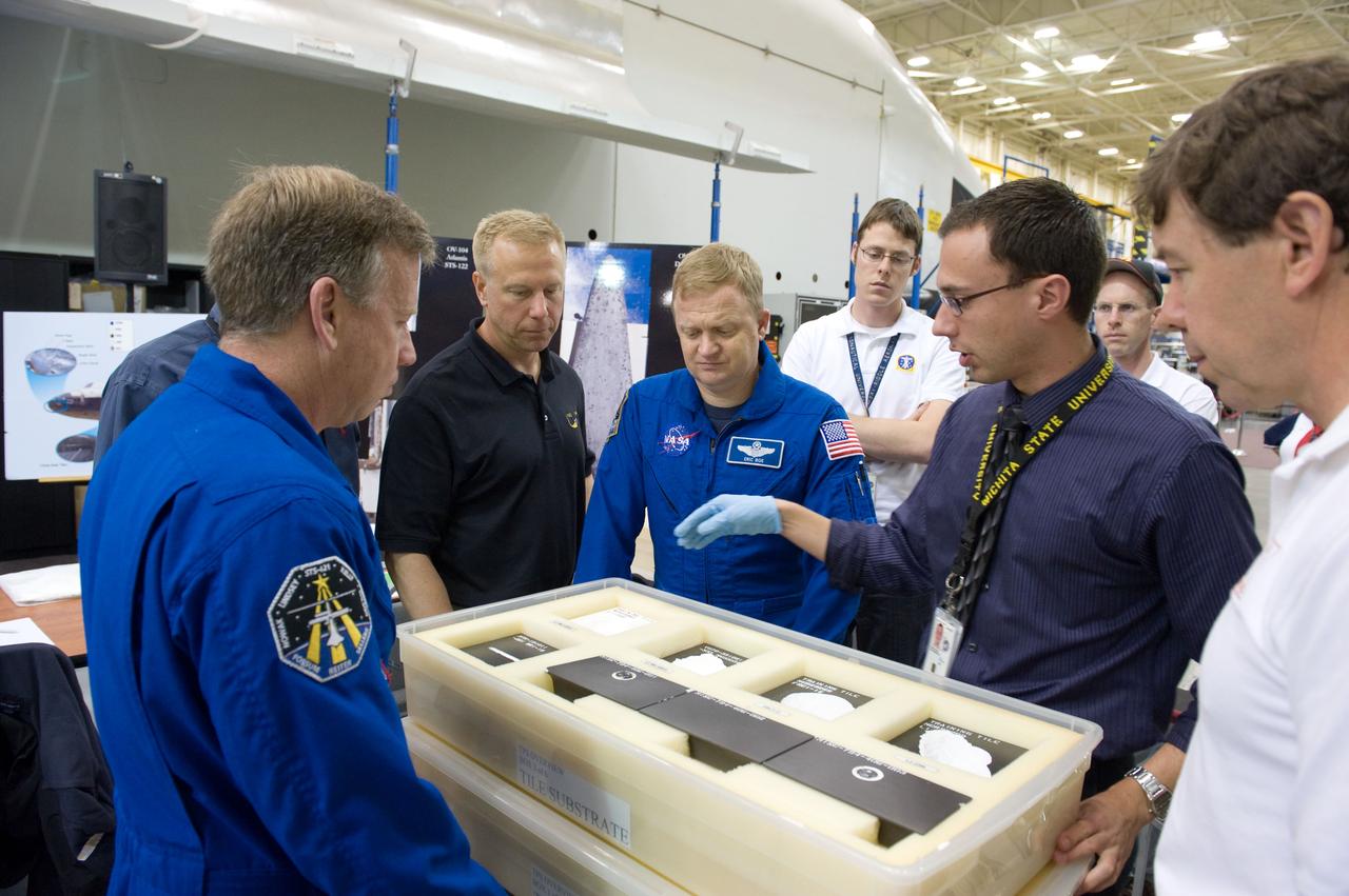 JSC2010-E-046552 (24 March 2010) --- NASA astronauts Steve Lindsey (left foreground), STS-133 commander; Alvin Drew (mostly obscured at left) and Tim Kopra, both mission specialists; Eric Boe, pilot; and Michael Barratt, mission specialist, participate in a training session in the Space Vehicle Mockup Facility at NASA's Johnson Space Center. Instructor Alexandros Kanelakos (second right) assisted the crew members.