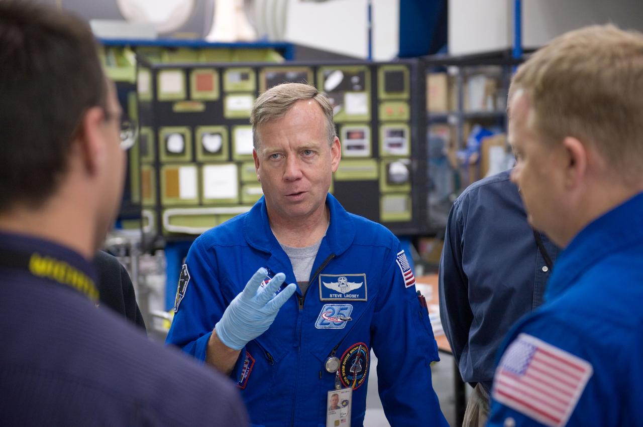 JSC2010-E-046557 (24 March 2010) --- NASA astronaut Steve Lindsey (facing camera), STS-133 commander; along with astronauts Eric Boe, pilot; and Alvin Drew (partially obscured at right), mission specialist, participate in a training session in the Space Vehicle Mockup Facility at NASA's Johnson Space Center.