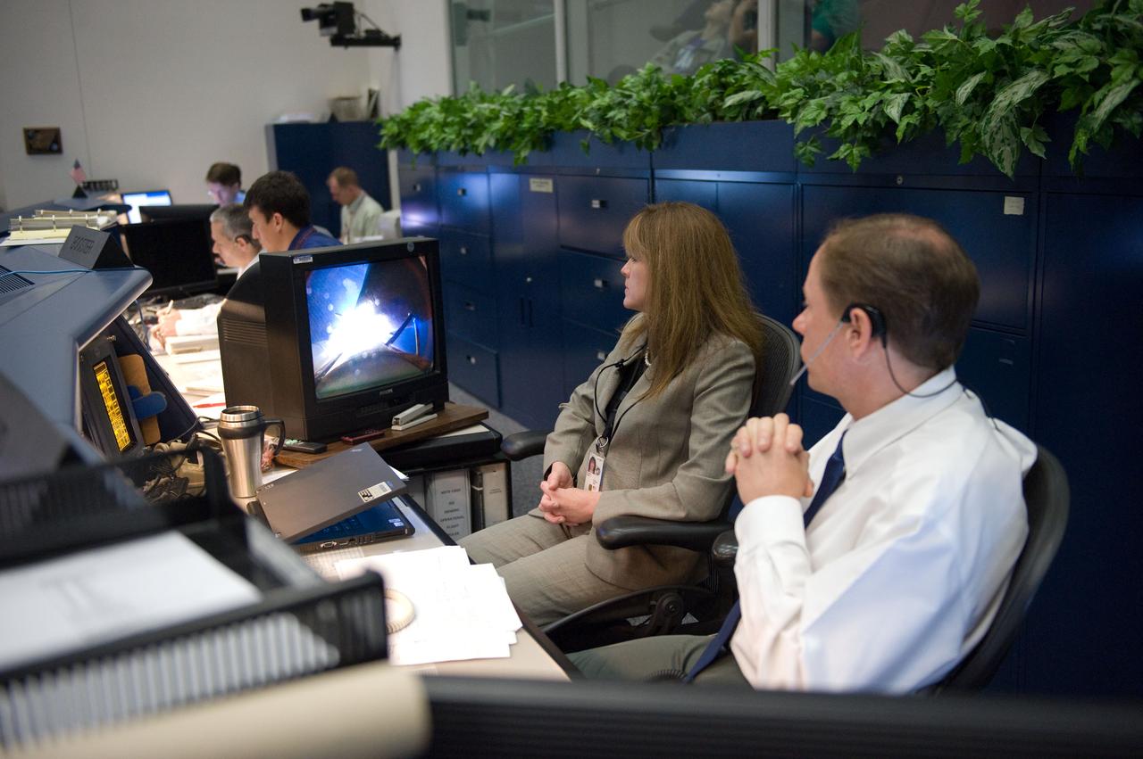 JSC2010-E-046805 (5 April 2010) --- John McCullough, chief of the Flight Director Office; and Janet Kavandi, deputy director, Flight Crew Operations, watch television screens at the Mission Operations Directorate (MOD) console in the space shuttle flight control room in the Mission Control Center at NASA's Johnson Space Center during launch a few hundred miles away in Florida, site of space shuttle Discovery's STS-131 liftoff.