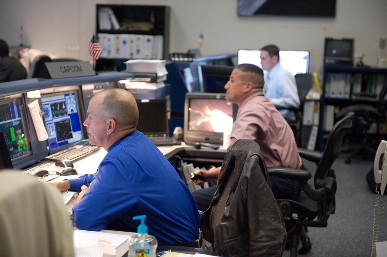 JSC2010-E-046808 (5 April 2010) --- Astronauts Rick Sturckow (foreground) and George Zamka, both spacecraft communicators (CAPCOM) for the STS-131 mission, watch the big screens in the space shuttle flight control room in the Johnson Space Center's Mission Control Center during launch countdown activities a few hundred miles away in Florida, site of space shuttle Discovery's STS-131 launch.