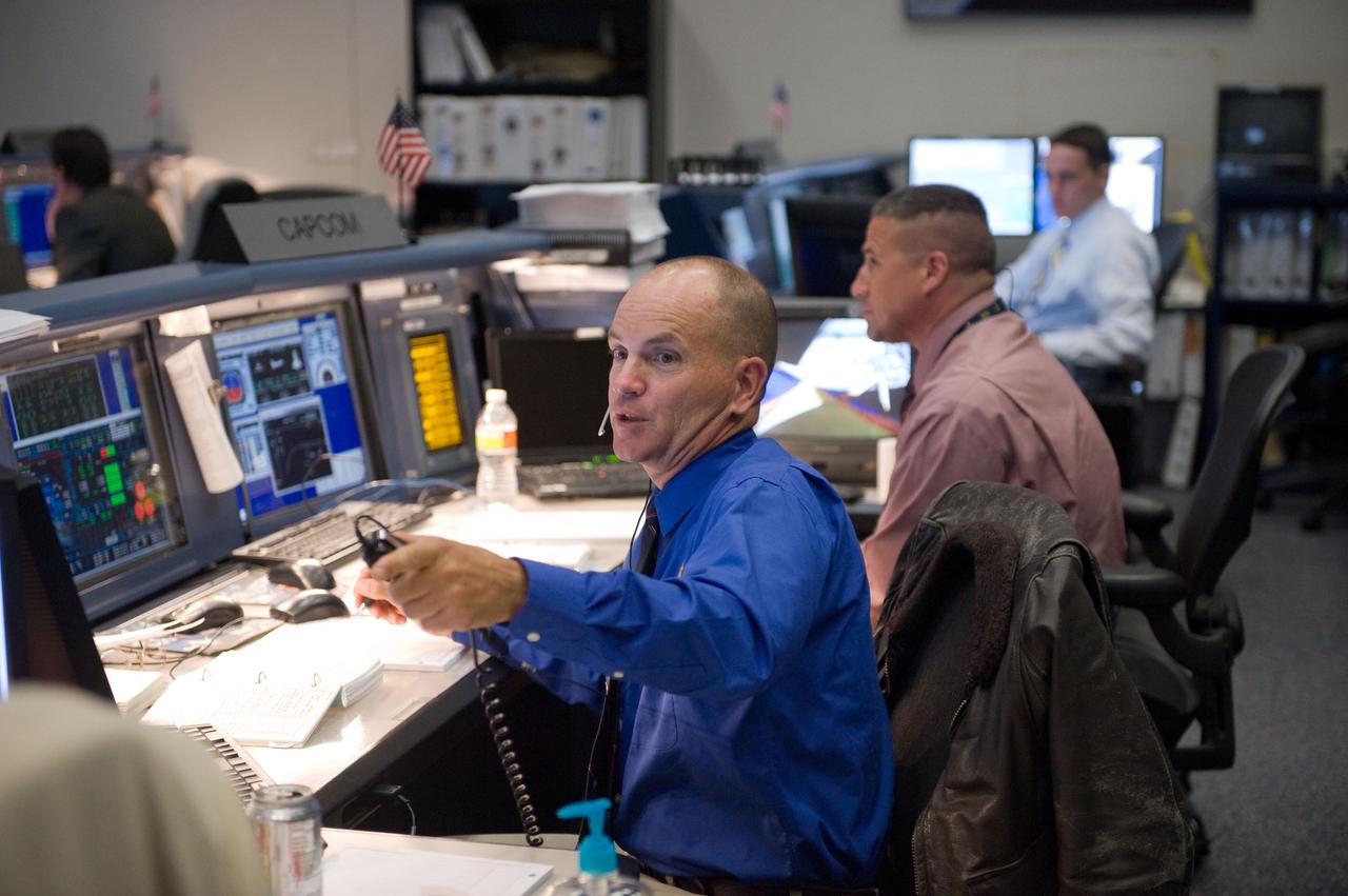 JSC2010-E-046809 (5 April 2010) --- Astronauts Rick Sturckow (foreground) and George Zamka, both spacecraft communicators (CAPCOM) for the STS-131 mission, are pictured in the space shuttle flight control room in the Johnson Space Center's Mission Control Center during launch countdown activities a few hundred miles away in Florida, site of space shuttle Discovery's STS-131 launch.