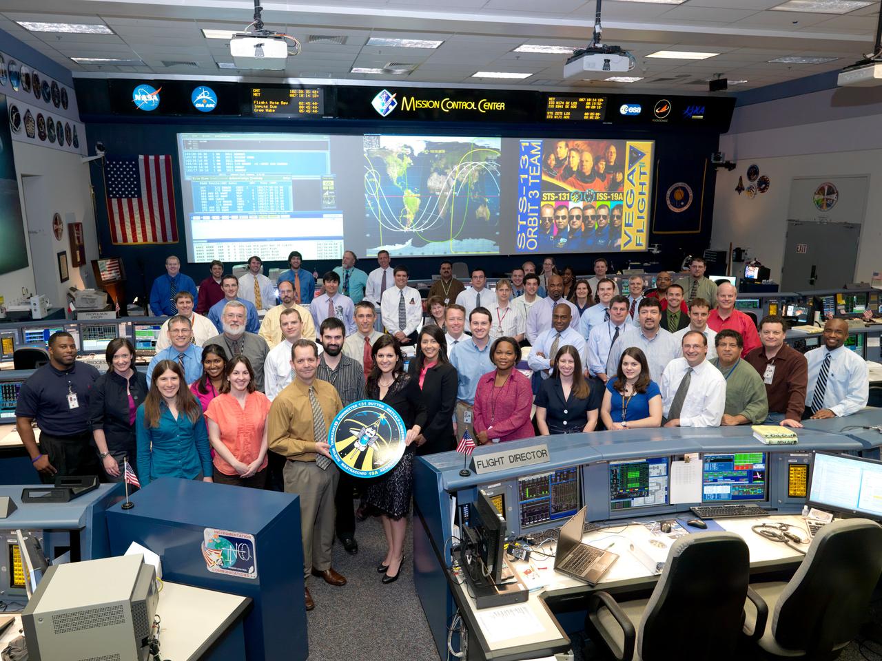 JSC2010-E-050902 (12 April 2010) --- The members of the STS-131 Planning flight control team pose for a group portrait in the space shuttle flight control room in the Mission Control Center at NASA's Johnson Space Center. Flight director Ginger Kerrick (center) is visible on the second row.